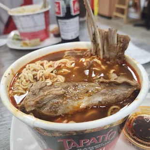 a bowl of ramen with meat and noodles