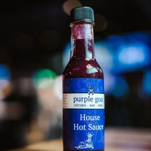 a bottle of hot sauce on a table