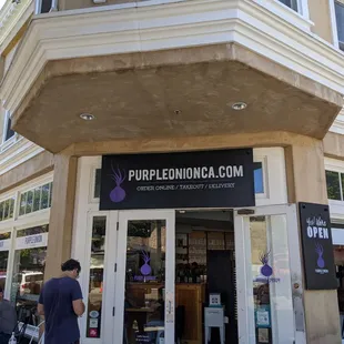 people walking in front of the building