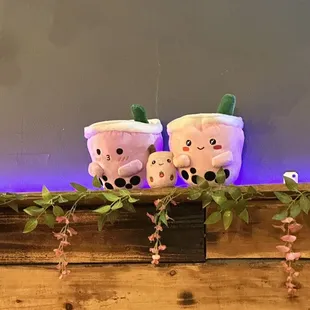 three cups of bubble tea on a shelf
