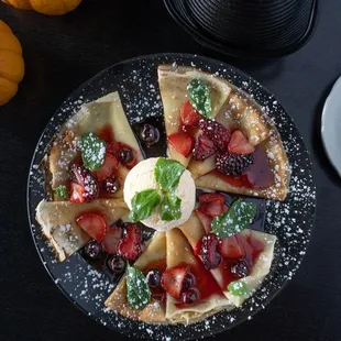 Crapes with vanilla ice cream and berries