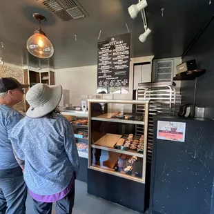 a man and a woman standing in front of a counter
