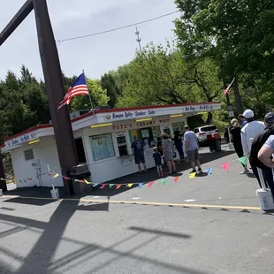 a line of people waiting outside a store