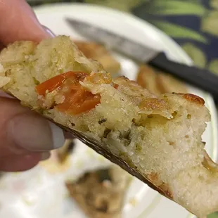 a hand holding a piece of bread