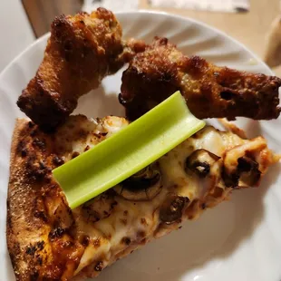 Wings, mushroom and chicken pizza slice, and celery.