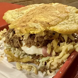 Todera (sweet corn pancake with cheese and pork, topped with nata)