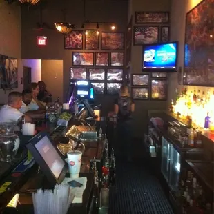 a bar with people sitting at the bar