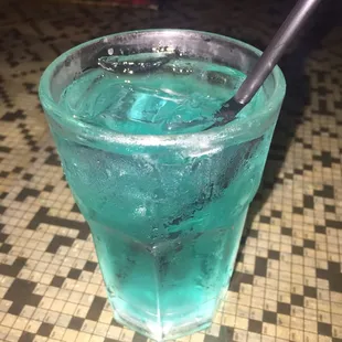 a blue drink with a spoon in it
