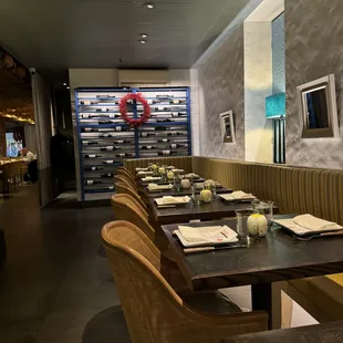 Pylos's back half adjacent to a bar counter with seating