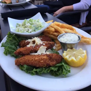 Fish and chips with tartar sauce and Cole slaw.