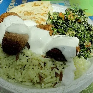 a plate of food with rice and meatballs