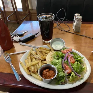 Shawarma sandwich with fries and two sauces.