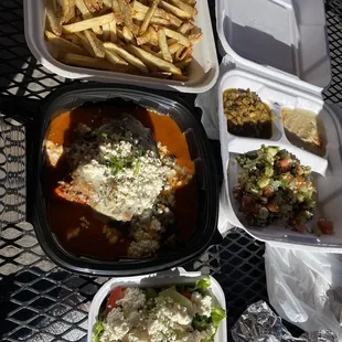 Homemade Moussaka, 3 appetizers (hummus, salata mishya, tabouleh) French Fries, and Greek Salad