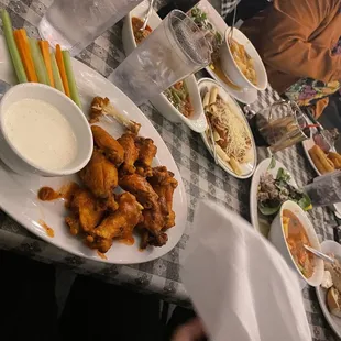 Buffalo Chicken Wings, at the end of the table oxtail Stew, and in the middle is the set up with Soup or Salad &amp; Bread