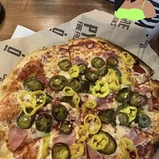 Thin crust pizza with spicy marinara, canadian bacon, banana peppers and fresh &amp; candied jalepenos