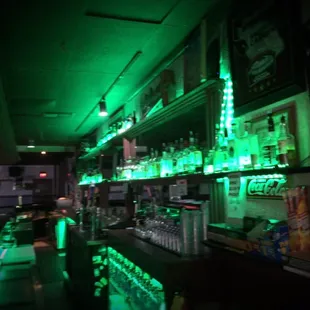 a bar with green lights