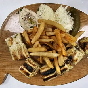 a plate of food with fries and a pickle