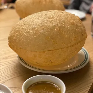 a plate of bread and a bowl of sauce