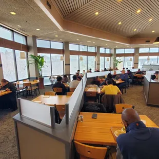 people sitting at tables in a restaurant