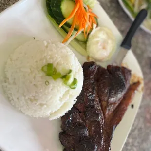 Grilled Pork chop with Rice, Egg, and pickled veggies.