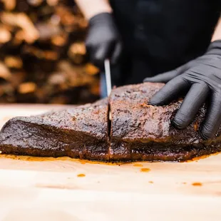 a man cutting a piece of meat