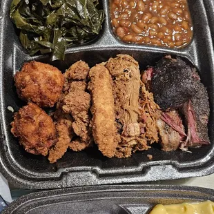 Take out meat sampler meal with baked beans, hush puppies, greens, and mac n cheese