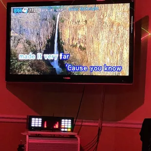  television with a picture of a waterfall on it