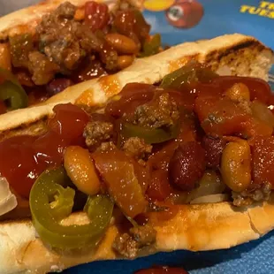 Two loaded chili dogs.