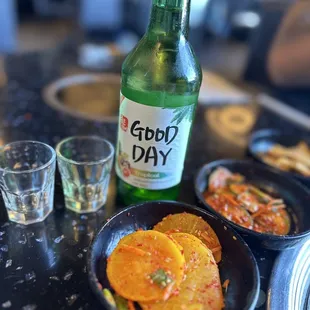 a bottle of beer and a plate of food