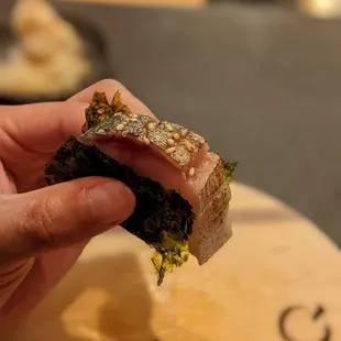 a hand holding a piece of food