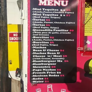 a menu on the side of a food truck