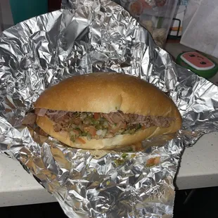 a sandwich wrapped in tin foil
