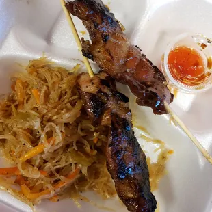 Half eaten Pancit noodles, BBQ sticks