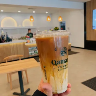 a person holding a cup of coffee