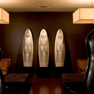 a row of surfboards in a dimly lit room