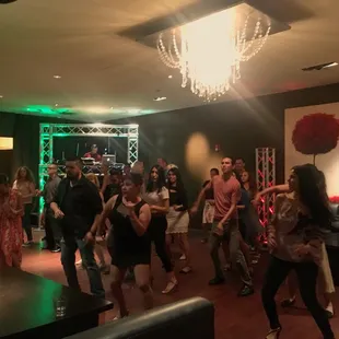 a group of people dancing at a party