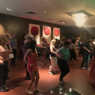 a group of people dancing at a party
