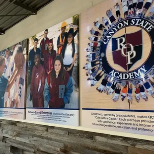a group of people standing in front of a large poster