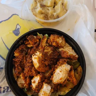 Chicken and rice bowl with side of mashed potatoes