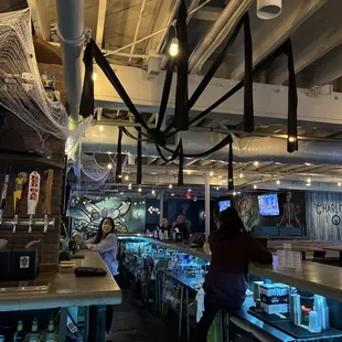 a bar with a spider web hanging from the ceiling