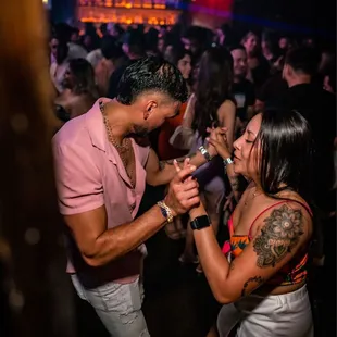 a man and a woman dancing at a party