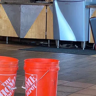 Large amounts of trash under the soda machine.