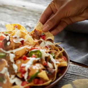 Nachos can be loaded with grilled adobo chicken, house-made pico de gallo and QDOBA&apos;s signature 3-cheese queso, free on any e...