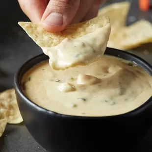 QDOBA&apos;s signature 3-cheese queso pairs perfectly with fried in-house tortilla chips or on any entrée at no additional charge!