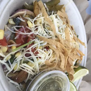 Burrito bowl with grilled peppers, chicken and tortilla chips