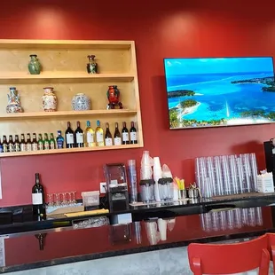 a bar with red chairs