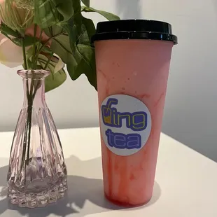 a glass vase with a flower in it