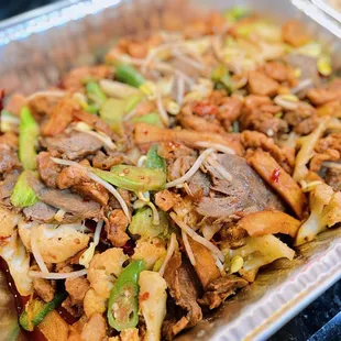 a tray of food with meat and vegetables