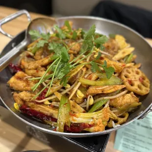 a pan of stir fried vegetables and rice