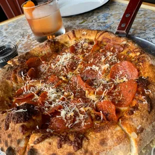 Pepperoni pizza and old fashioned.